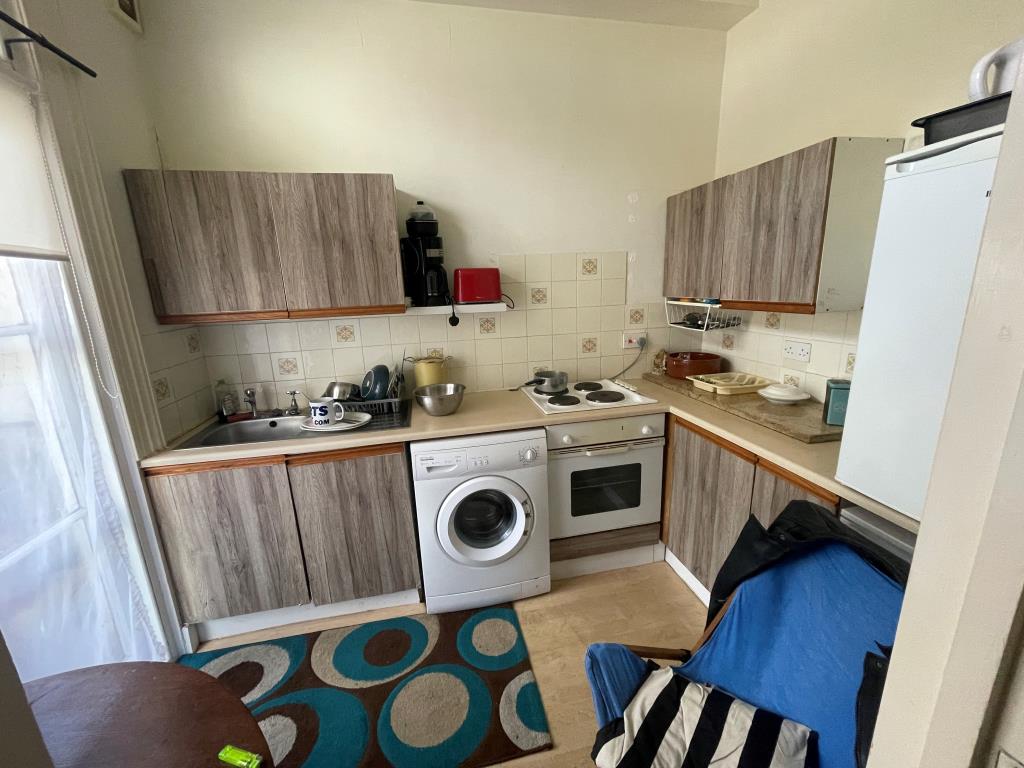 Lot: 129 - FREEHOLD BLOCK OF THREE FLATS FOR INVESTMENT - Middle flat's kitchen with access to balcony